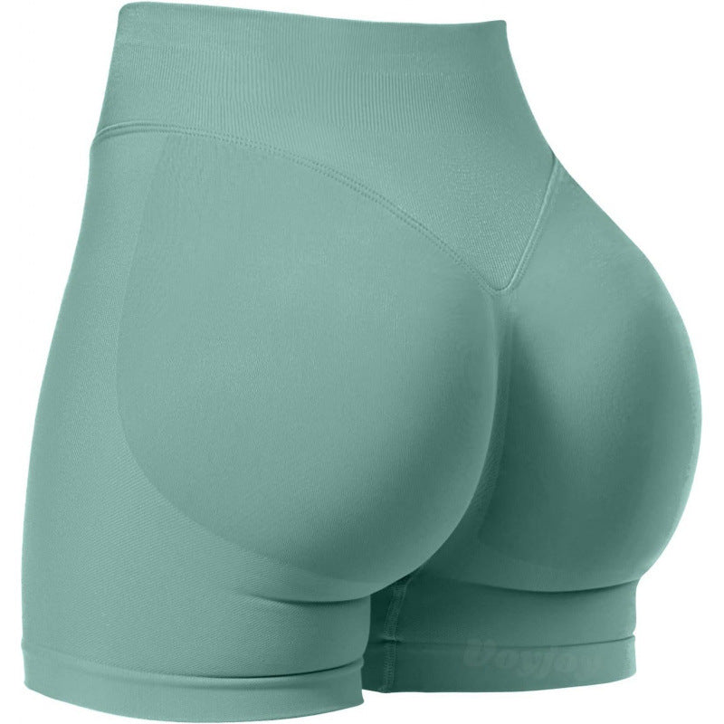 High‑waisted, seamless 3″ yoga shorts with a sculpted, peach‑lift fit and quick‑dry performance for running and training.