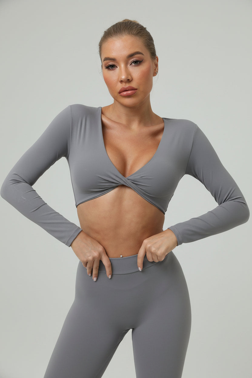 Soft-touch, long‑sleeve performance top with a chic front knot for effortless studio style.